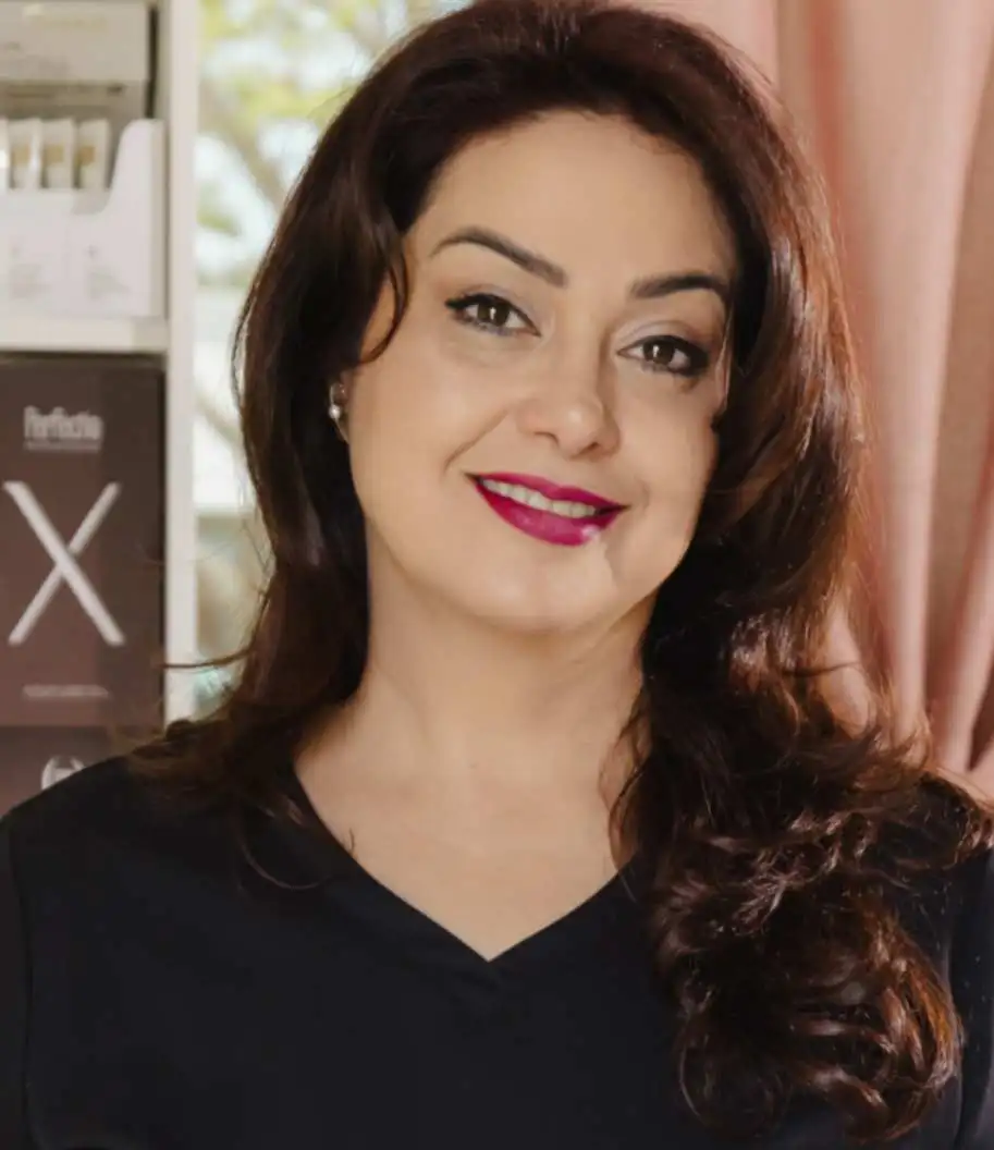 Portrait of Kiana in a black top inside her skincare studio